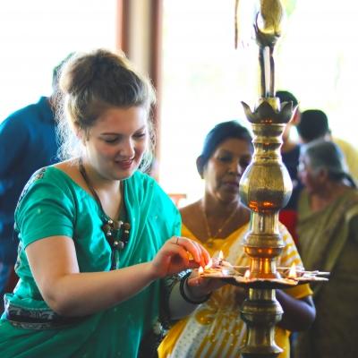 A Projects Abroad volunteer lights a lamp in Sri Lanka A volunteer lighs an oil lamp during a ceremony in Sri Lanka